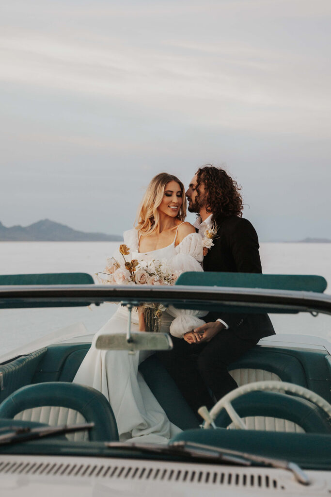 bride and groom salt flats elopement photo in a classic car