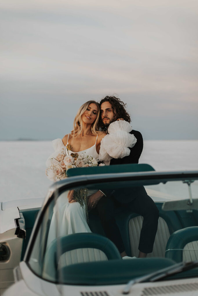 bride and groom salt flats elopement photo in a classic car