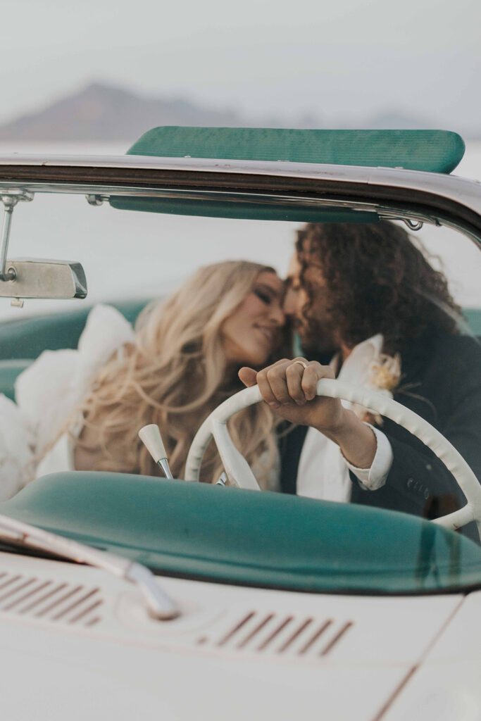 bride and groom salt flats elopement photo in a classic car