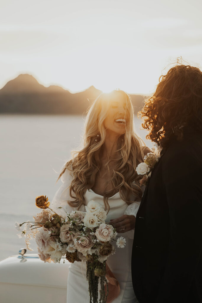 bride and groom salt flats elopement photo standing by a classic car