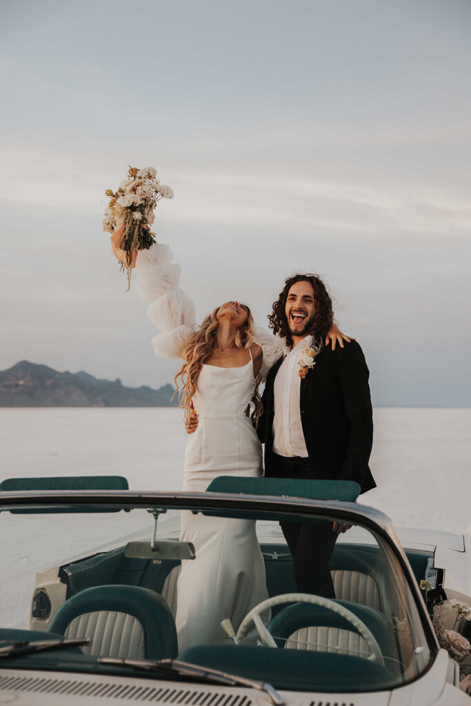 bride and groom salt flats elopement photo in a classic car