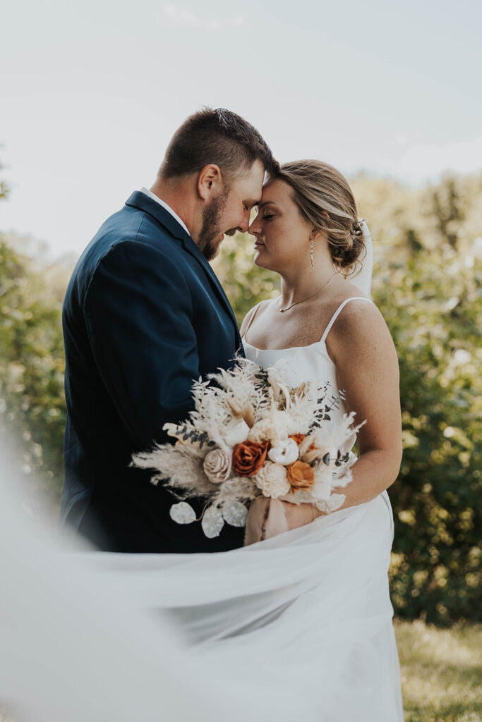 candid and romantic bride and groom portrait outdoors