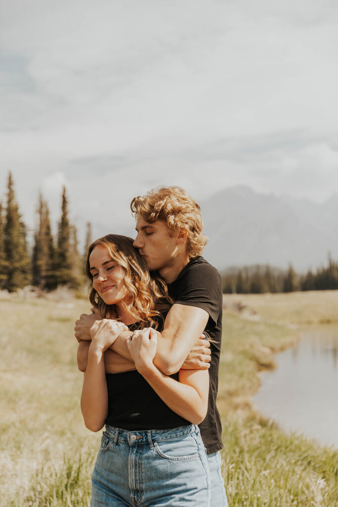 romantic banff engagement photos in a grassy field