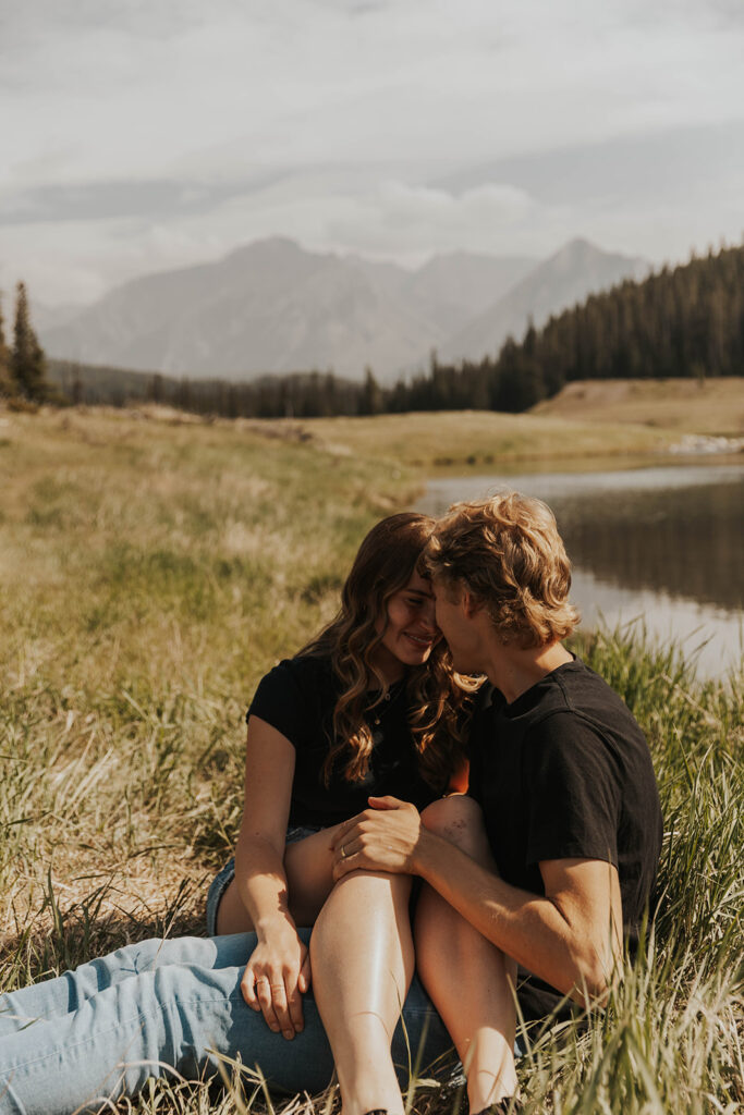 caleb and lauren sitting in a grassy field 