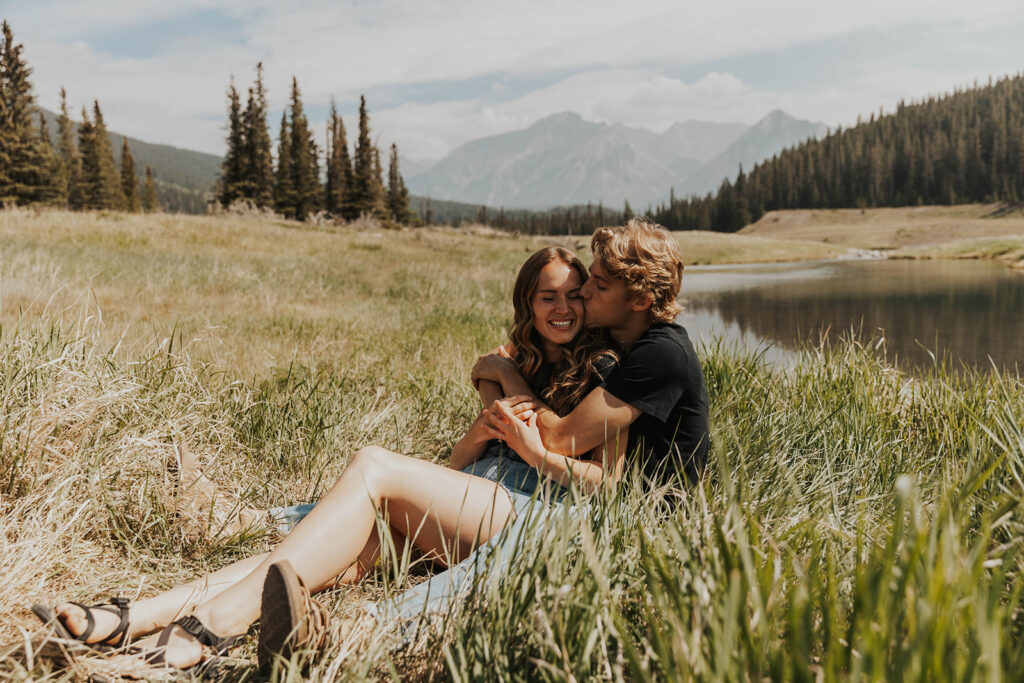 romantic banff engagement photos in a grassy field