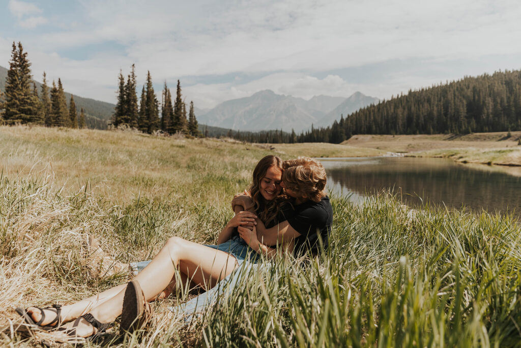 caleb and lauren sitting in a grassy field 