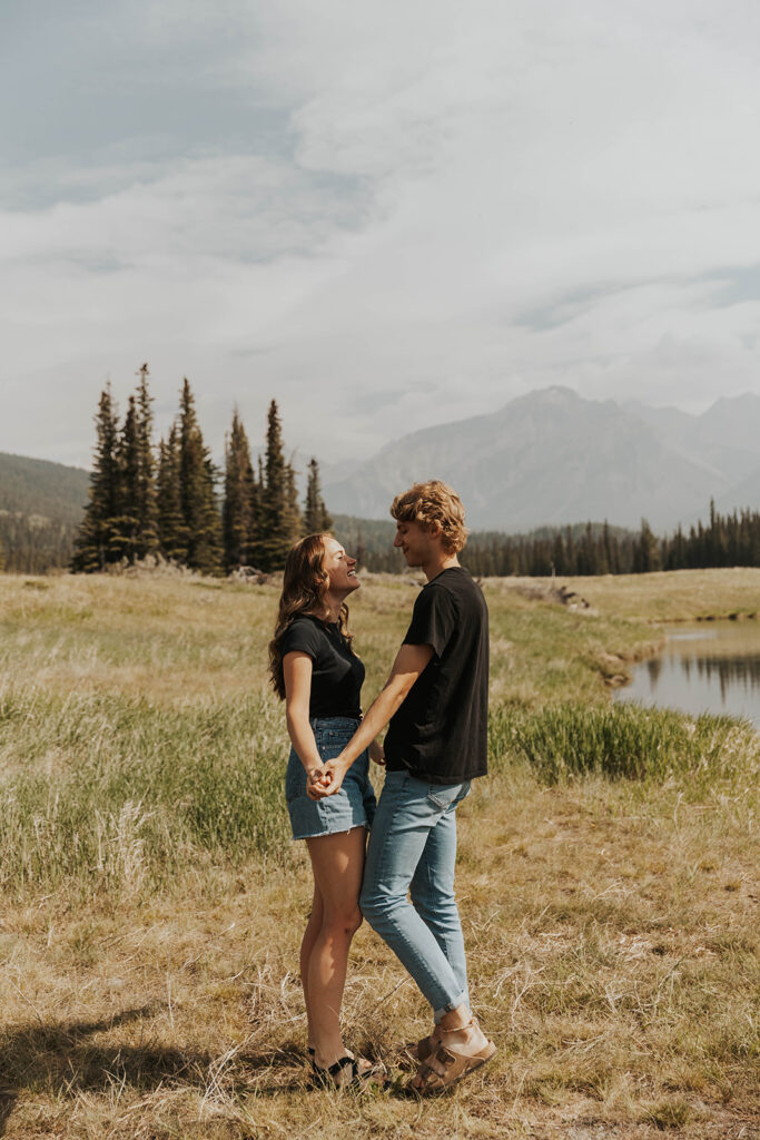 romantic banff engagement photos in a grassy field