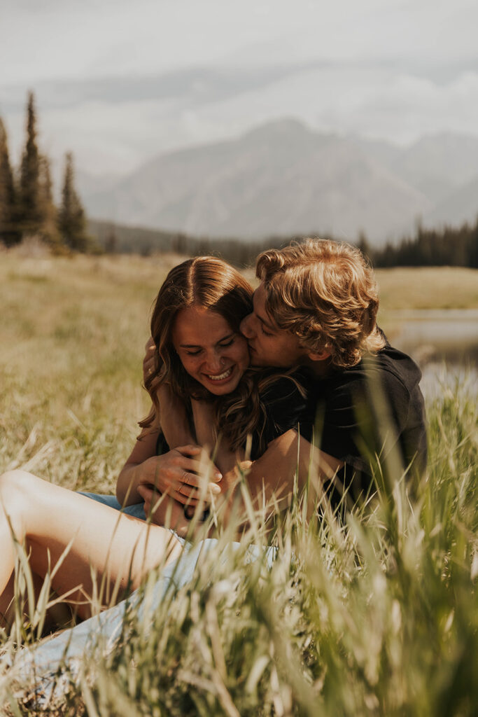 caleb and lauren sitting in a grassy field 