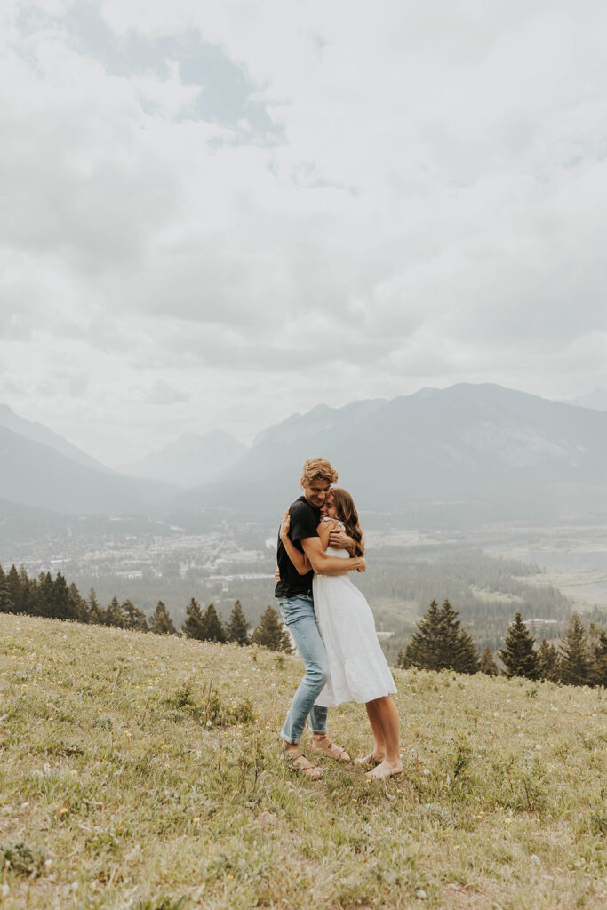 romantic banff engagement photos in a grassy field