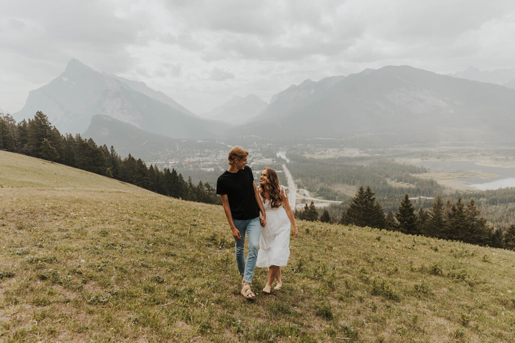 romantic banff engagement photos in a grassy field