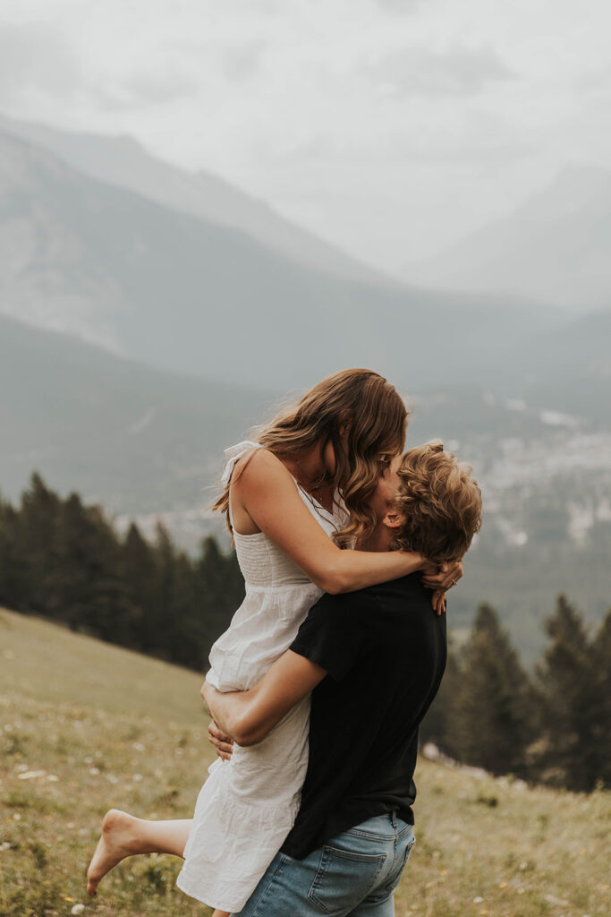 romantic banff engagement photos in a grassy field