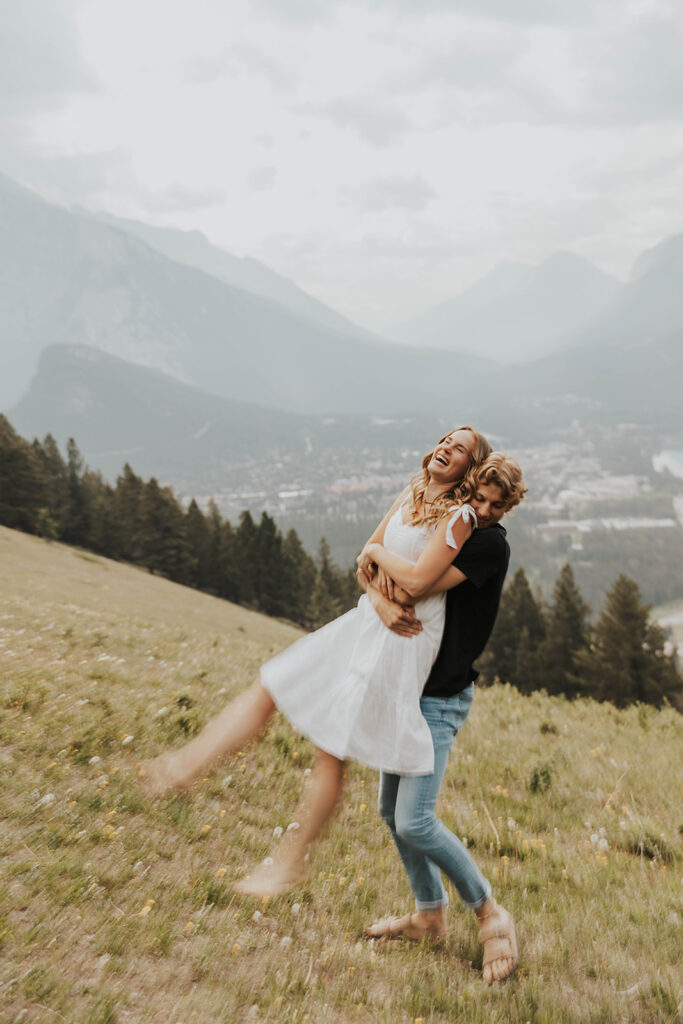 caleb and lauren wearing neutral engagement outfits for their banff engagement photos