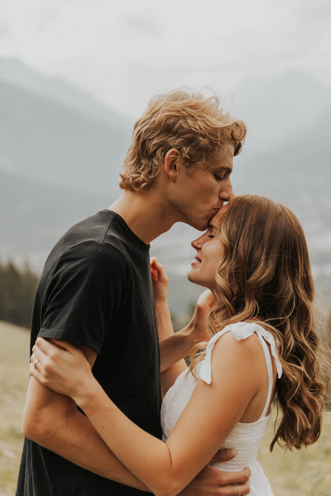 romantic banff engagement photos in a grassy field