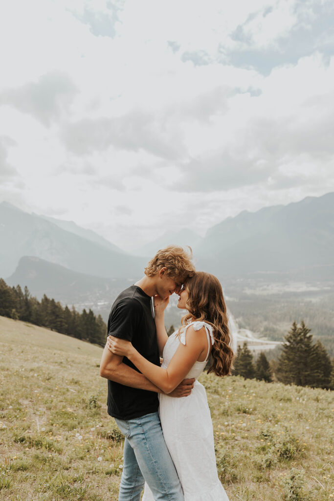 caleb and lauren wearing neutral engagement outfits for their banff engagement photos