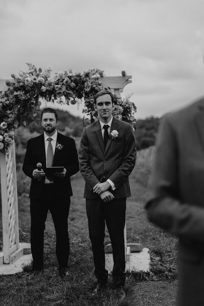 groom awaiting his bride at the end of the aisle