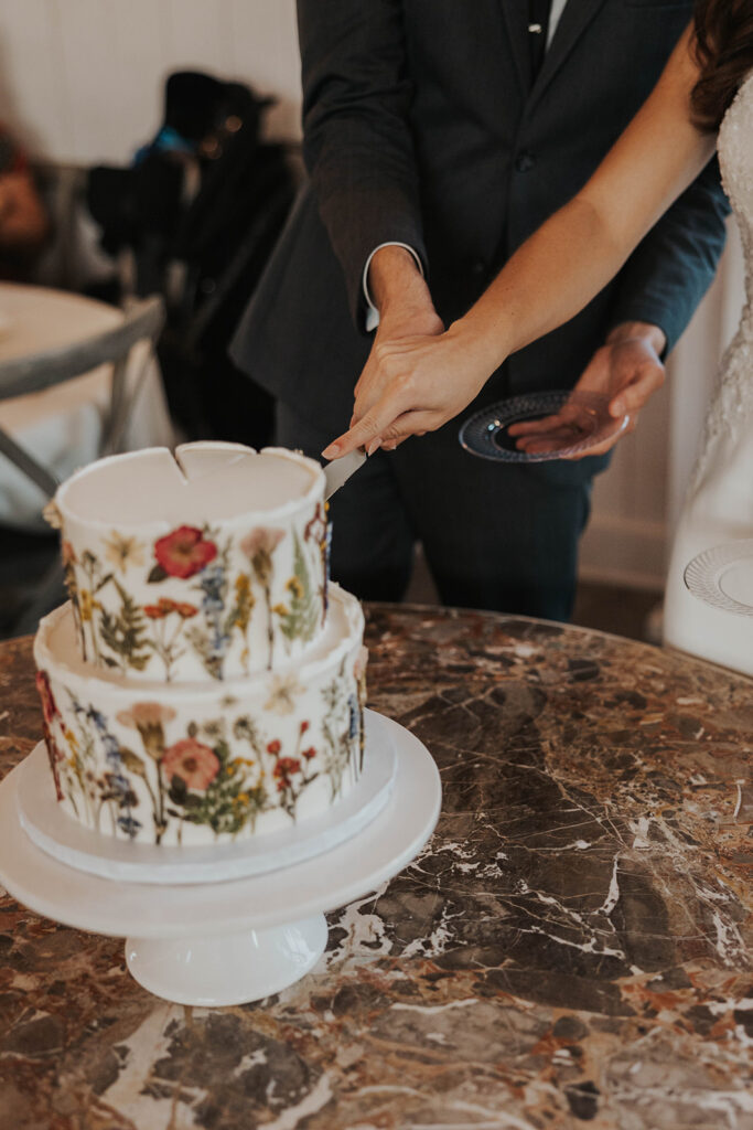 bride and groom cutting their cake