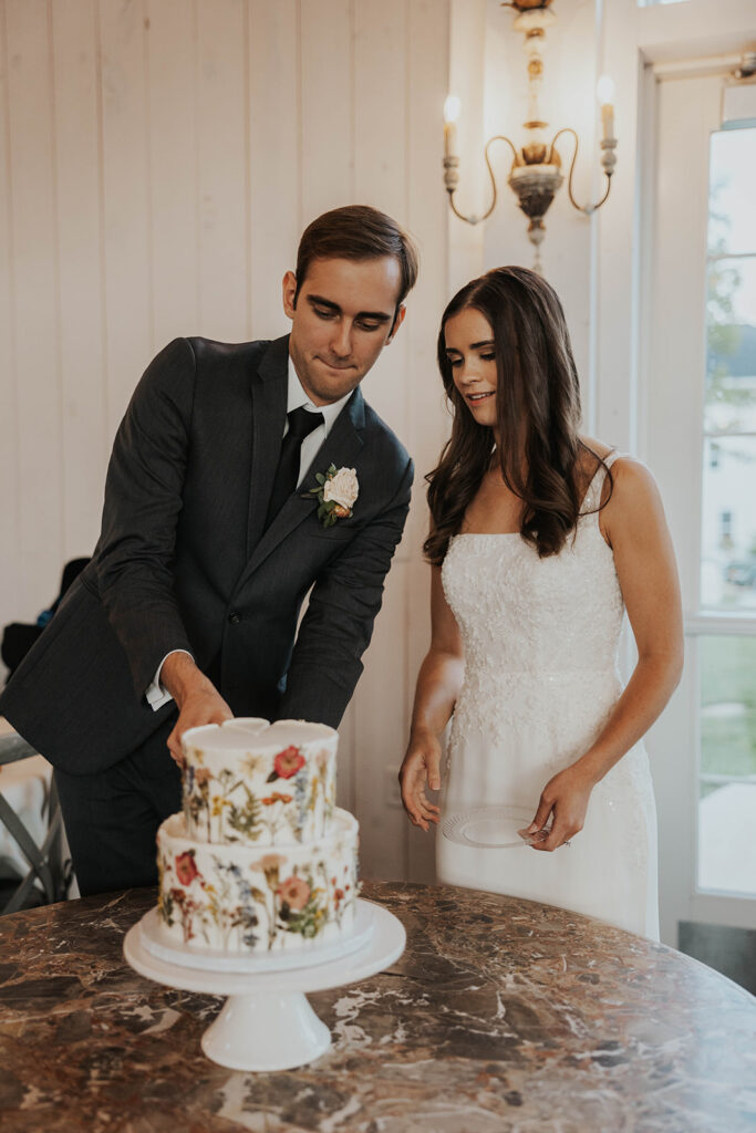 bride and groom cutting their cake