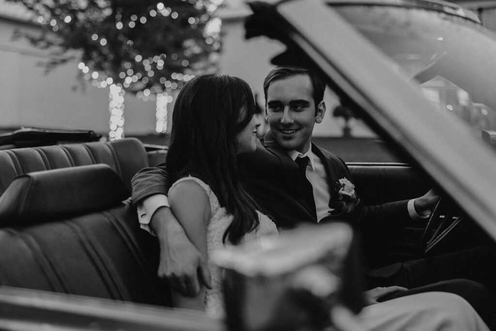 bride and groom preparing to drive away in a vintage car