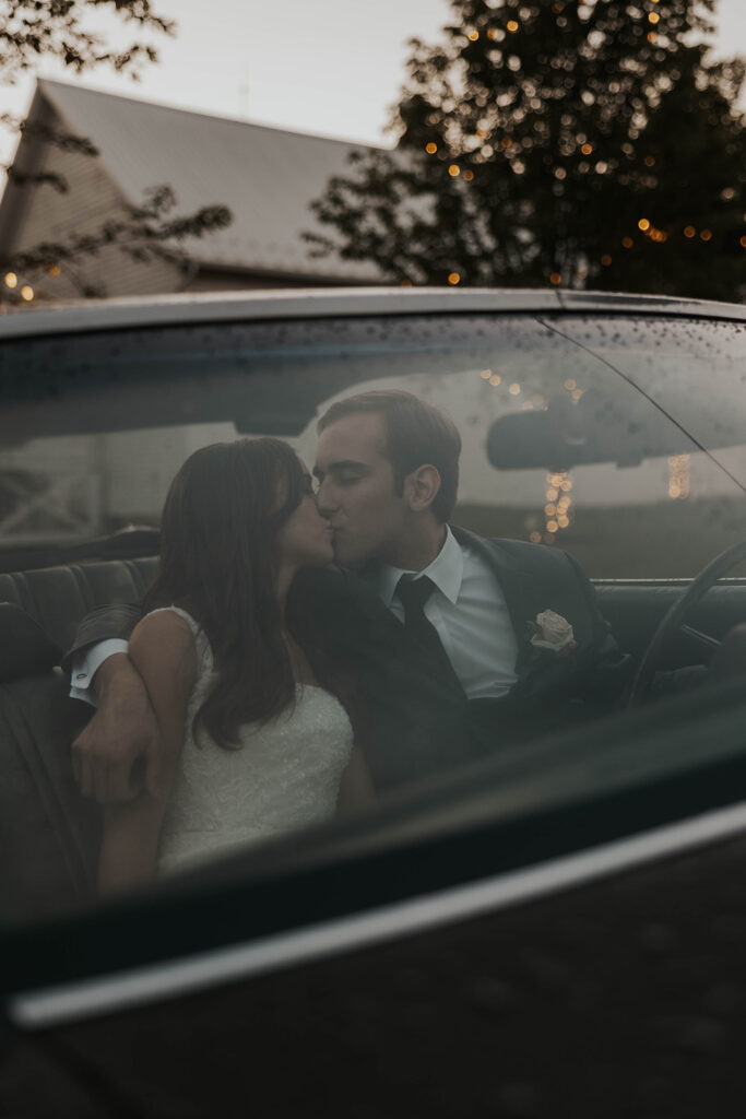 bride and groom preparing to drive away in a vintage car