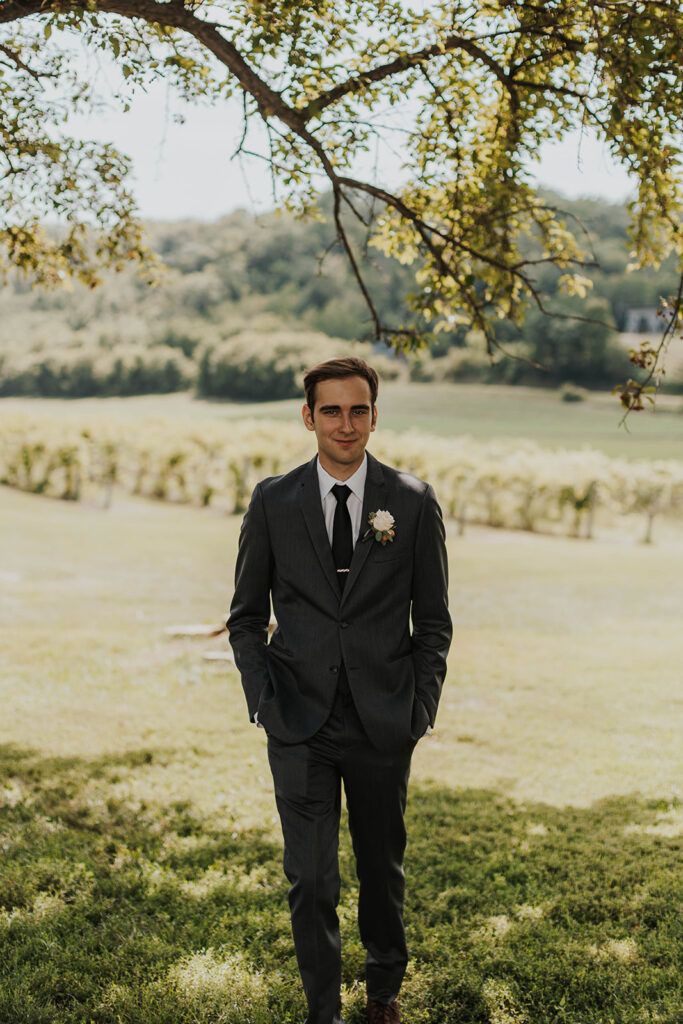 groom portrait in a gorgeous green vineyard