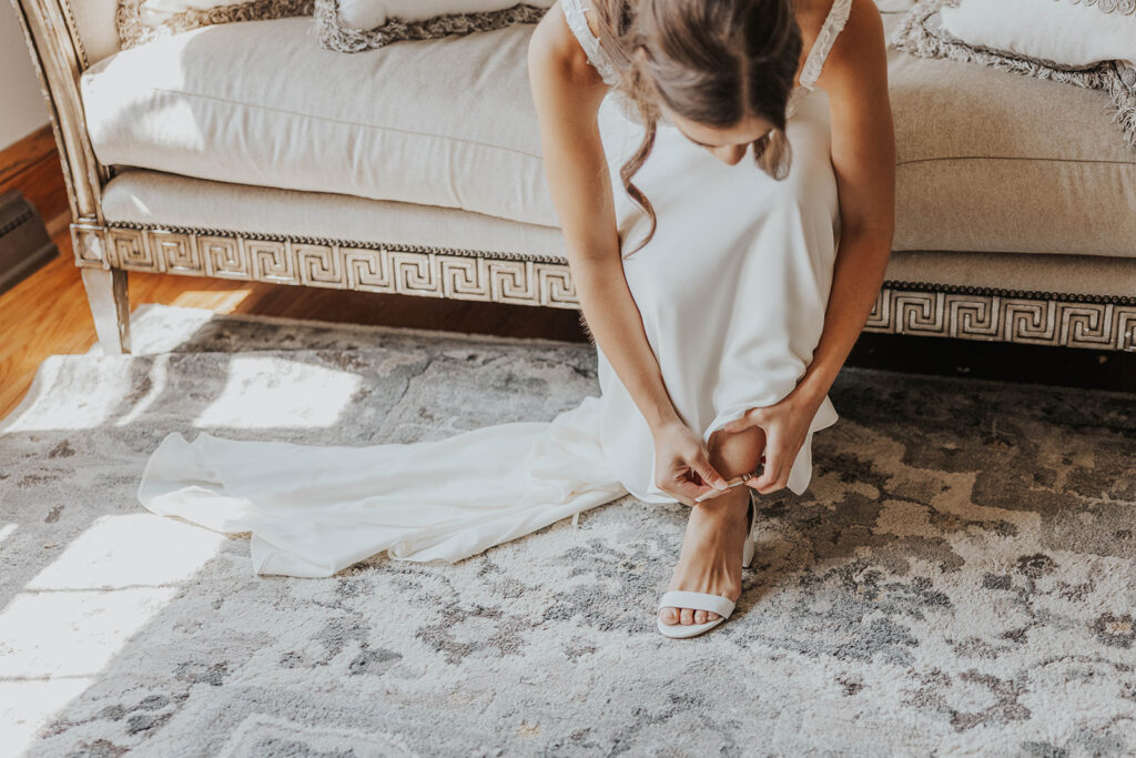 bride getting ready in a cozy, neutral color room