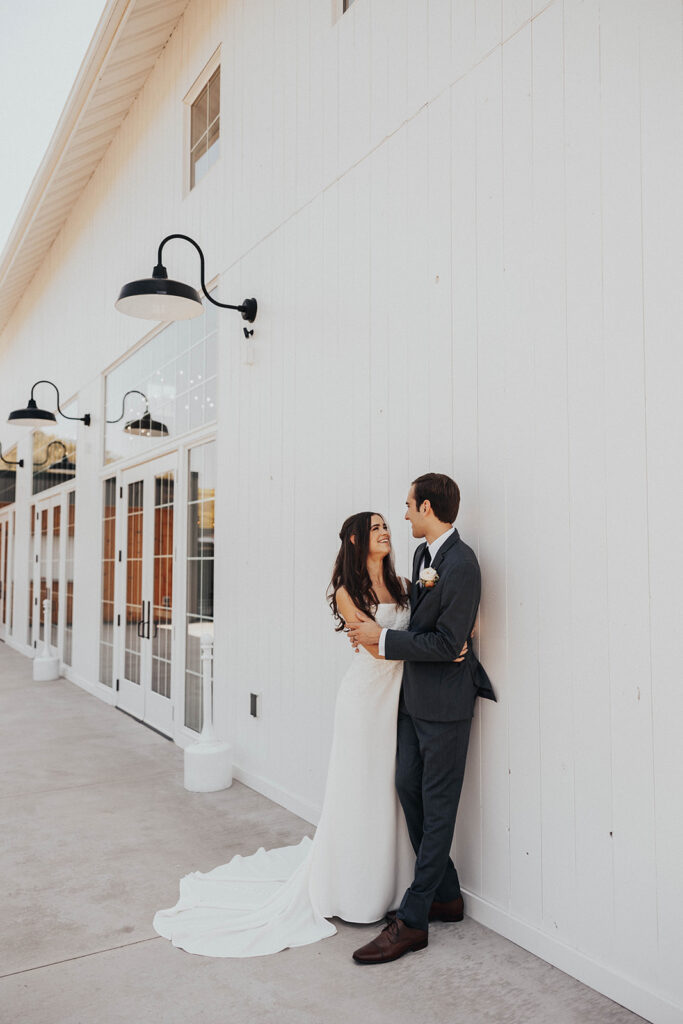 playful bride and groom looking at each other