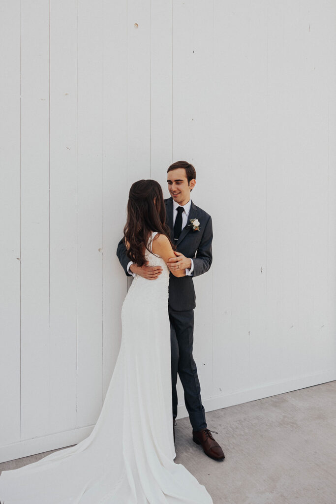 playful bride and groom looking at each other