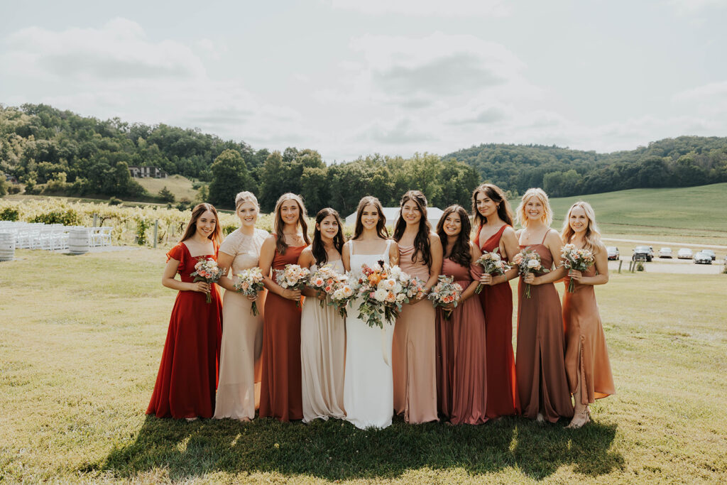 bride and bridesmaids, bridesmaids wearing mismatched terracotta bridesmaid dresses