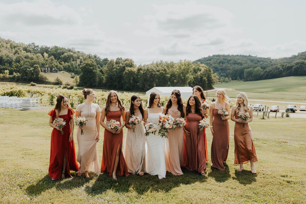 bride and bridesmaids, bridesmaids wearing mismatched terracotta bridesmaid dresses