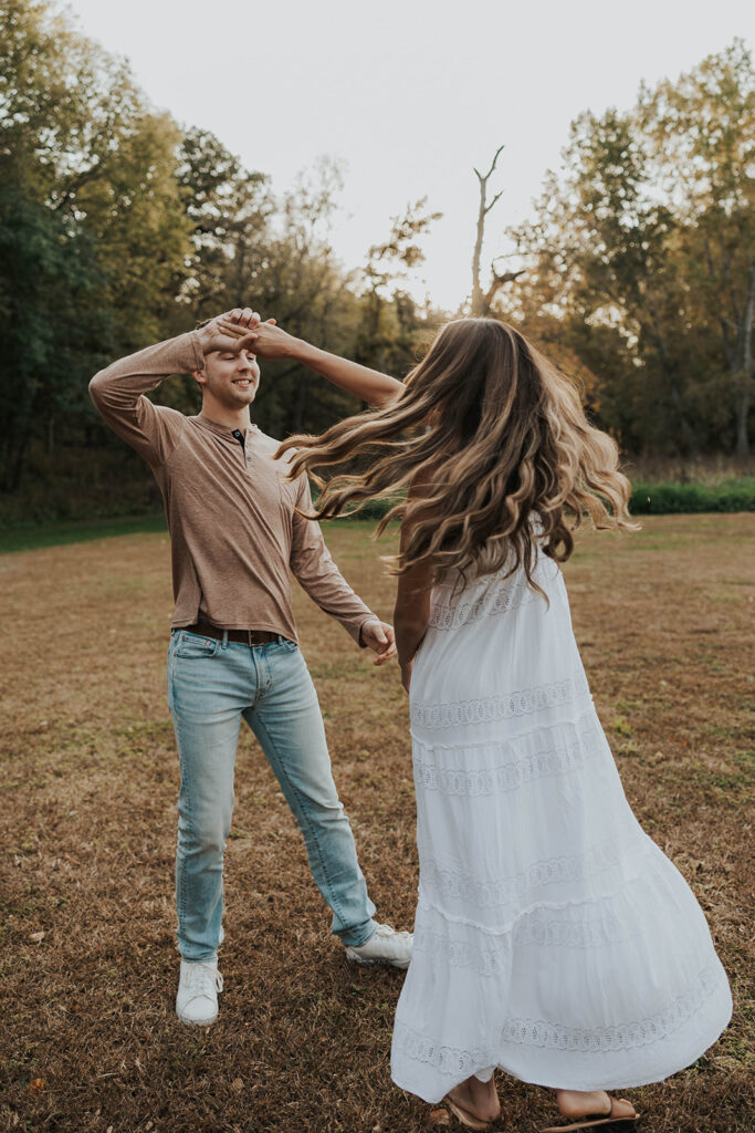 Sienna and Wyatt playing around in a park for their fall engagement session