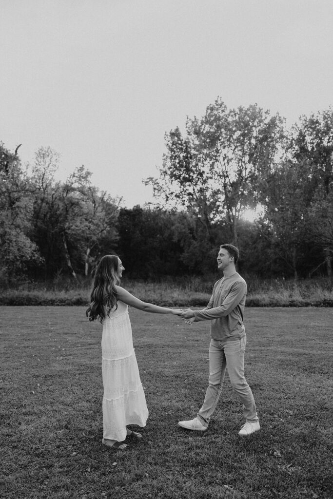 Sienna and Wyatt playing around in a park for their fall engagement session