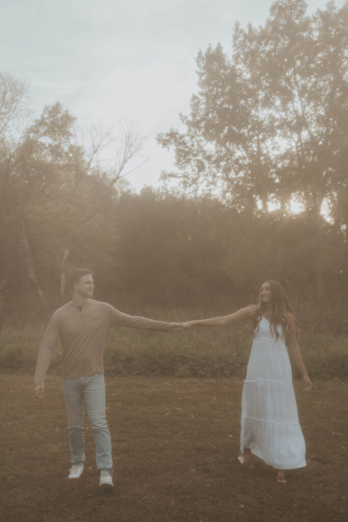 Sienna and Wyatt playing around in a park for their fall engagement session