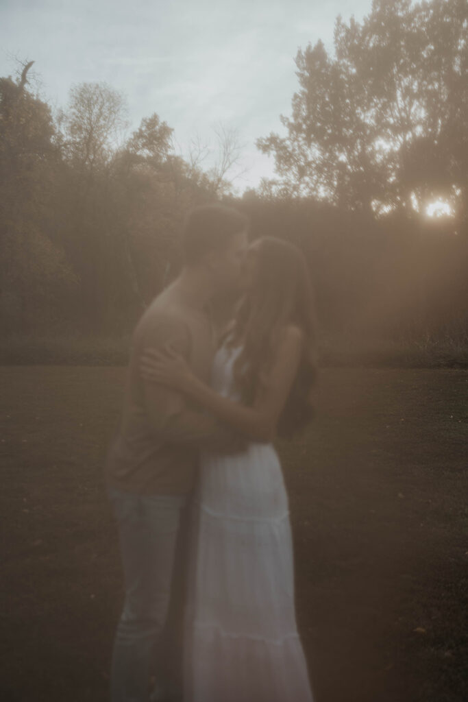 Sienna and Wyatt playing around in a park for their fall engagement session