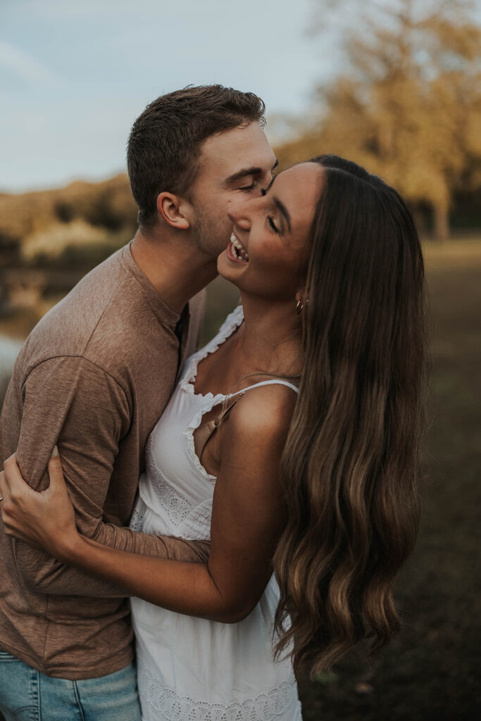 playful and candid Sienna and Wyatt kissing and fooling around for their engagement session