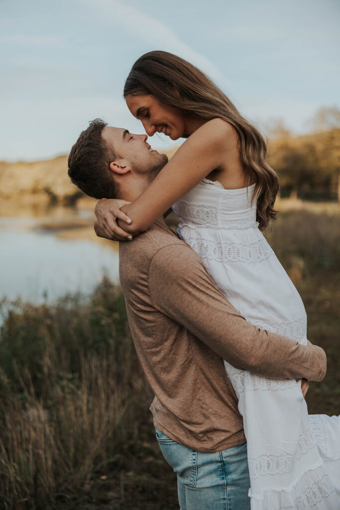 couple playing around outside for their engagement photos