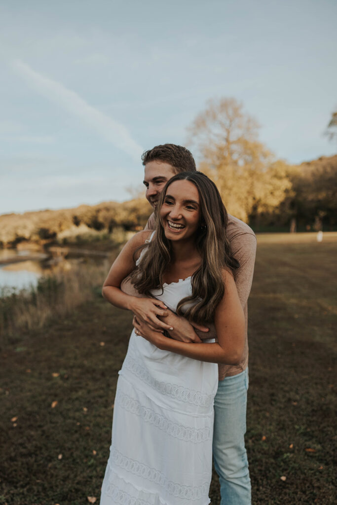 couple playing around outside for their engagement photos