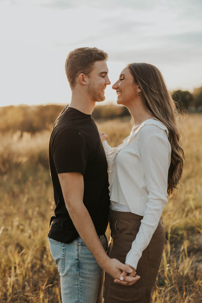 romantic engagement photos of Sienna and Wyatt in a golden field