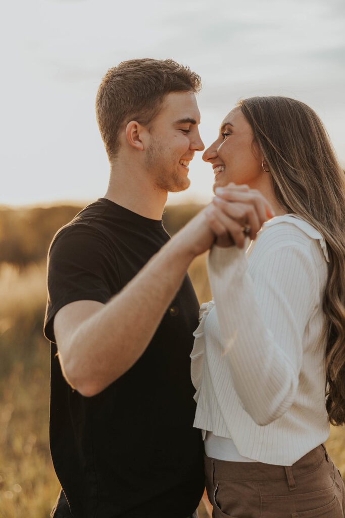 playful and candid Sienna and Wyatt kissing and fooling around for their engagement session