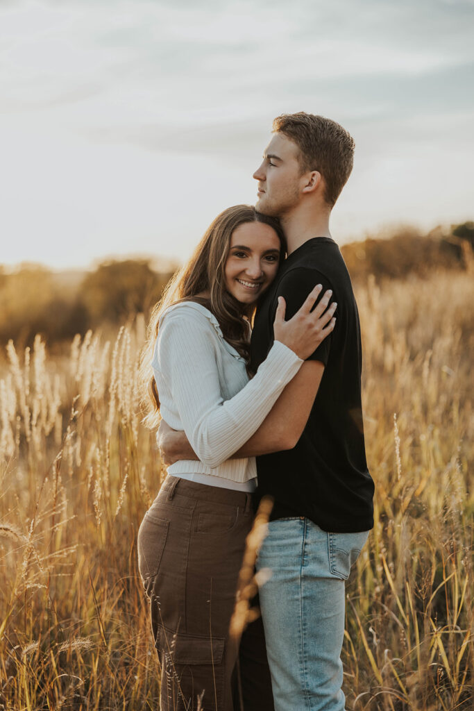 romantic engagement photos of Sienna and Wyatt in a golden field