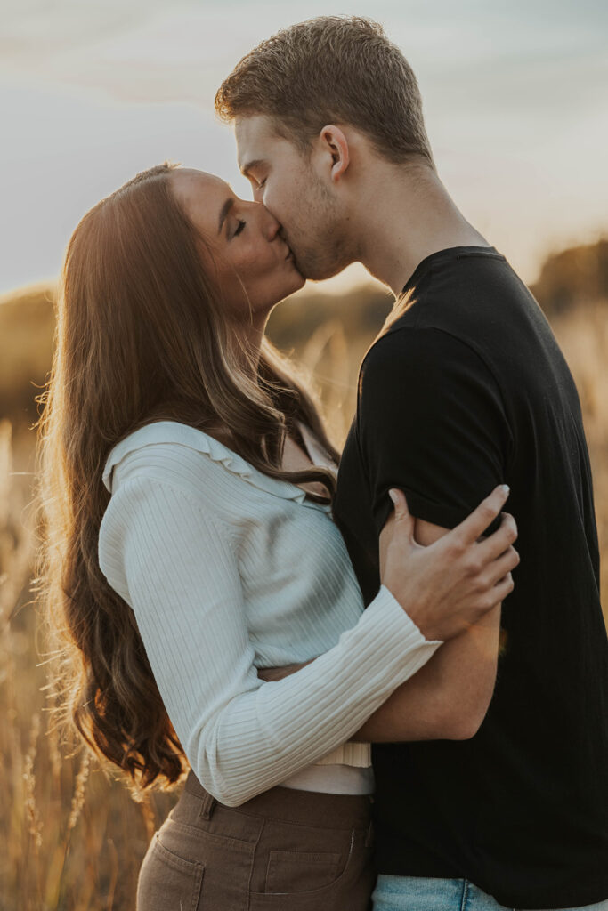 playful and candid Sienna and Wyatt kissing and fooling around for their engagement session