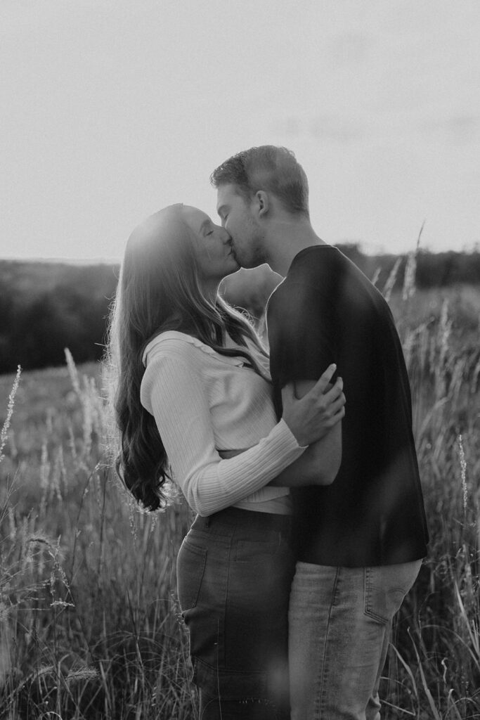 romantic engagement photos of Sienna and Wyatt in a golden field