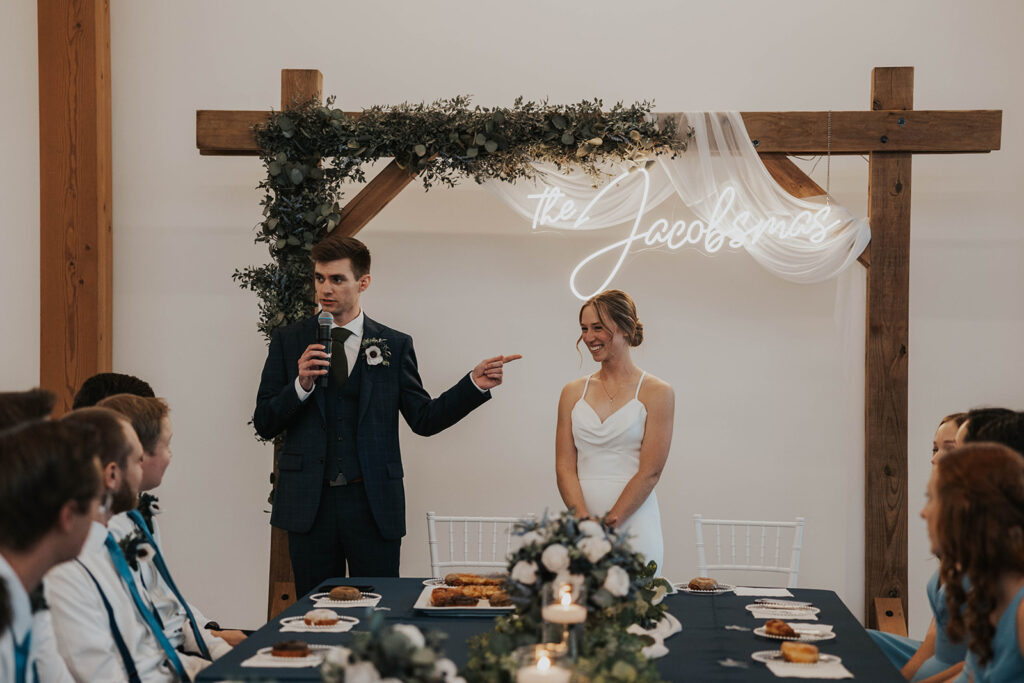 groom making a speech during during their wedding reception in Des Moines Heritage Center