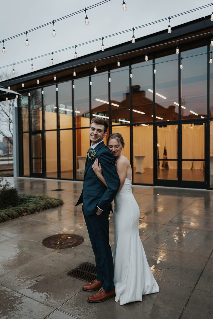 intimate bride and groom portrait outdoors with Des Moines Heritage Center in the backdrop