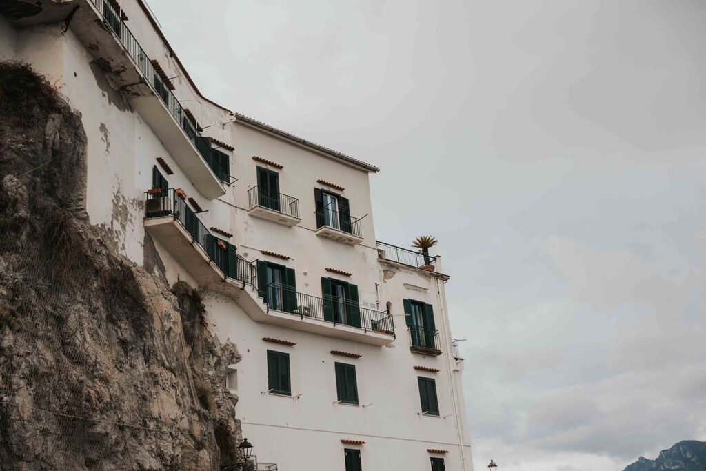 a rustic building with balconies overlooking the mediterranean sea