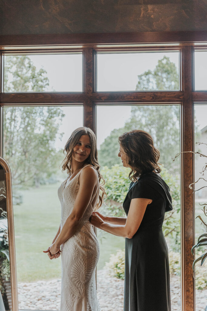 bride getting ready photos by a window