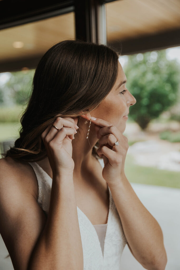 bride getting ready photos by a window