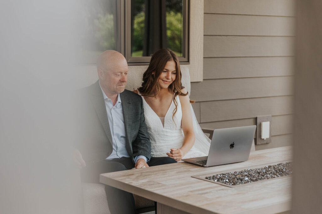 bride and dad going through a wedding slideshow