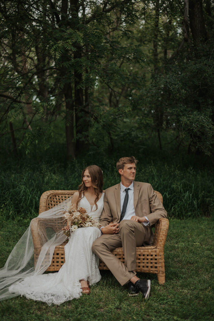 boho bride and groom outdoor photos on a wicker chair