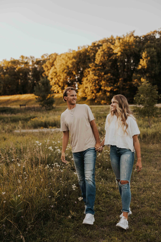 playful and romantic field engagement photos in Sibley State Park, MN