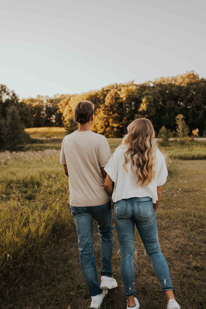 playful and romantic field engagement photos in Sibley State Park, MN